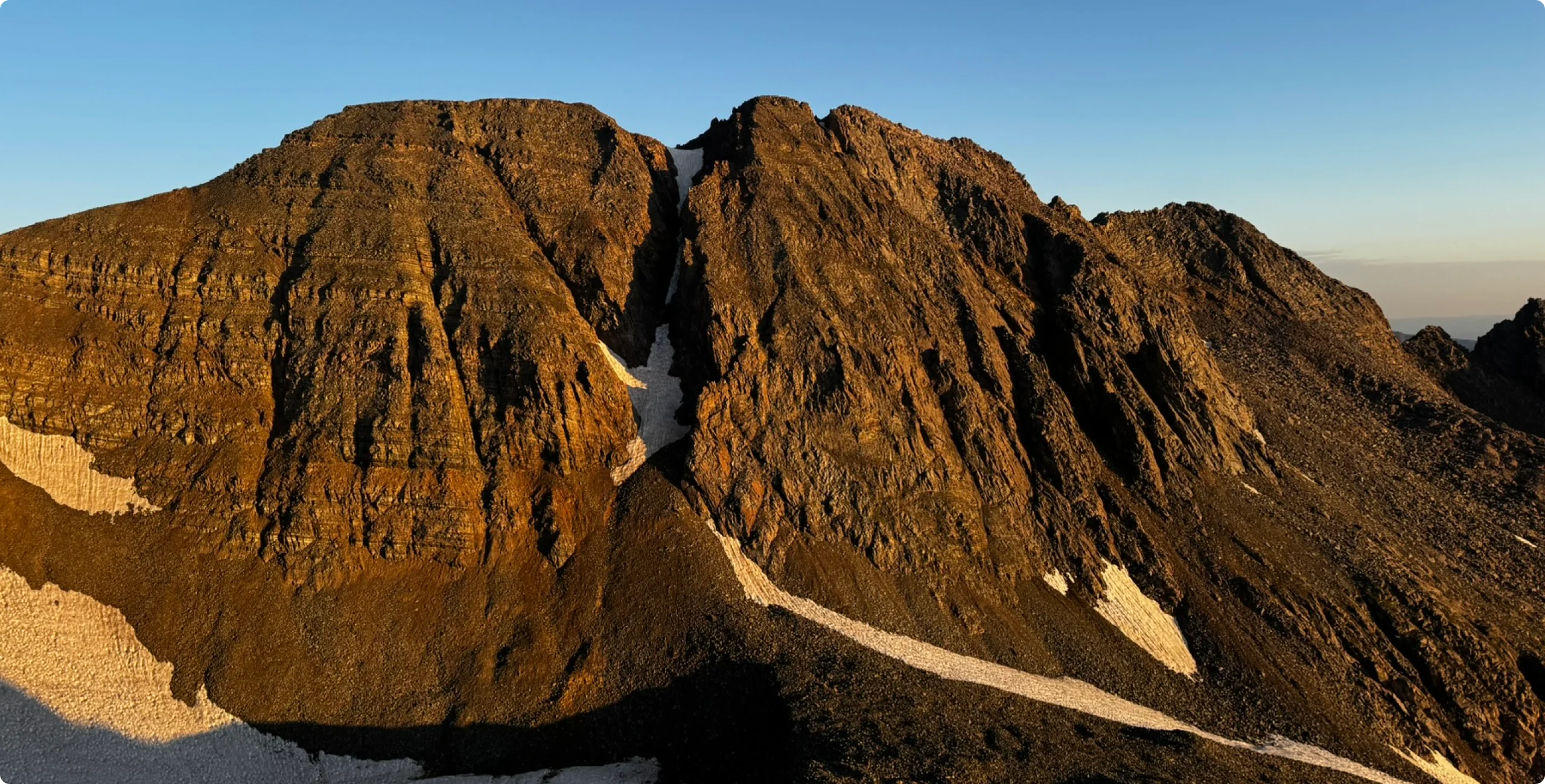 Alpenglow on a rugged alpine ridgeline at sunrise